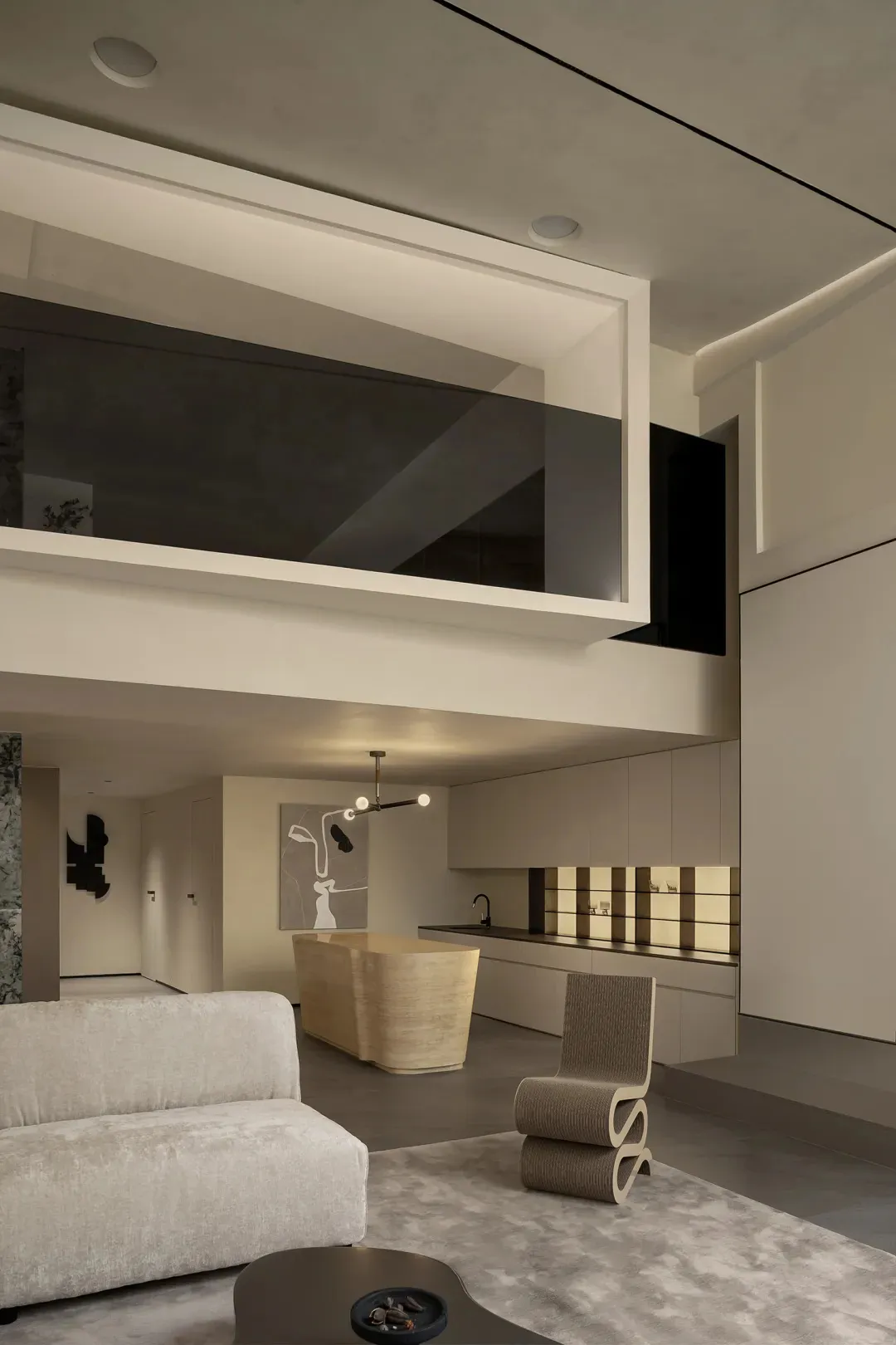 A cozy, minimalist residential interior with concrete finishes and modern furnishings, featuring an open-plan living area and