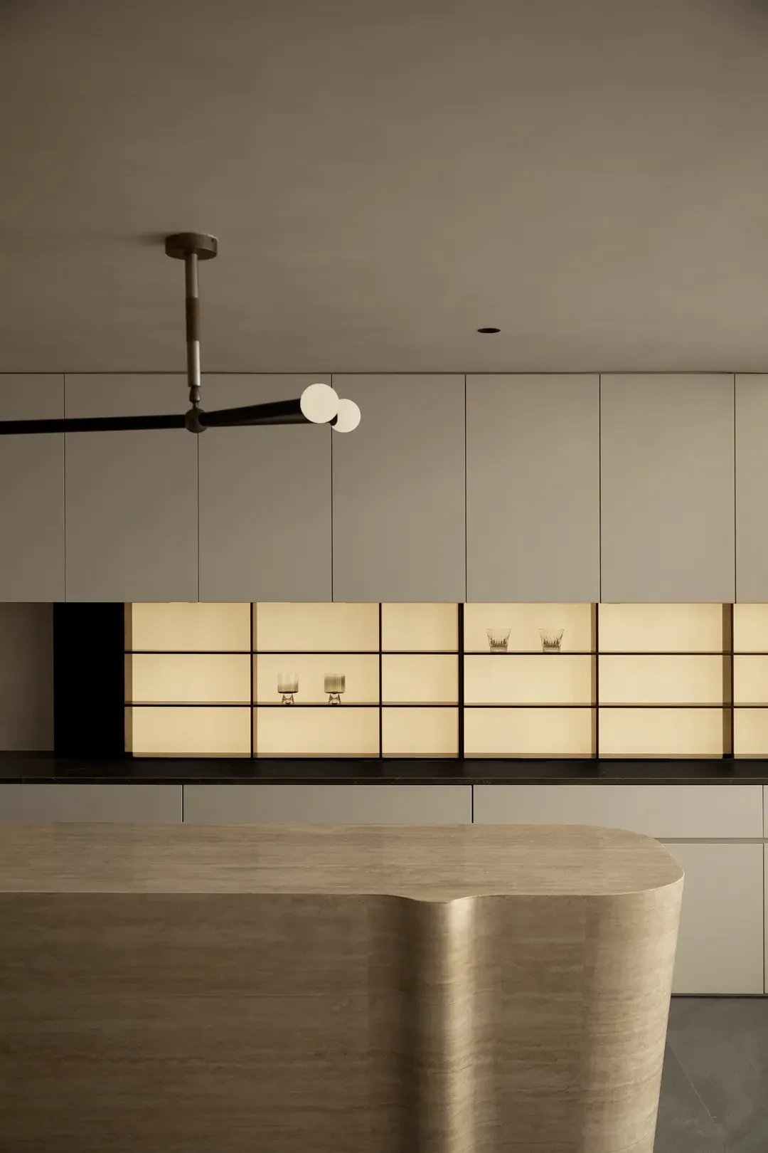 Modern kitchen with contemporary open shelves and a sleek, curved wooden island.