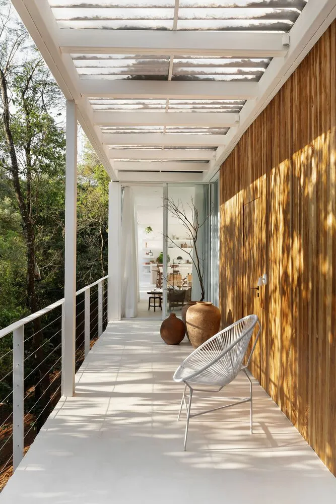Modern minimalist outdoor space featuring wood materials and a white chair.