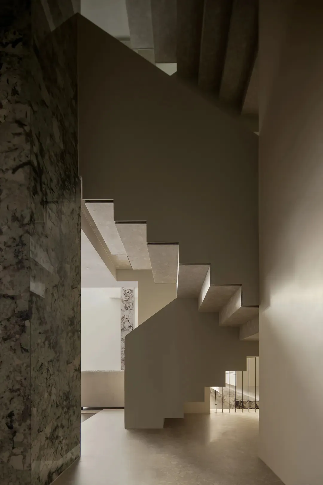 Concrete staircase with marble columns and white walls in a minimalist home interior design rendering.