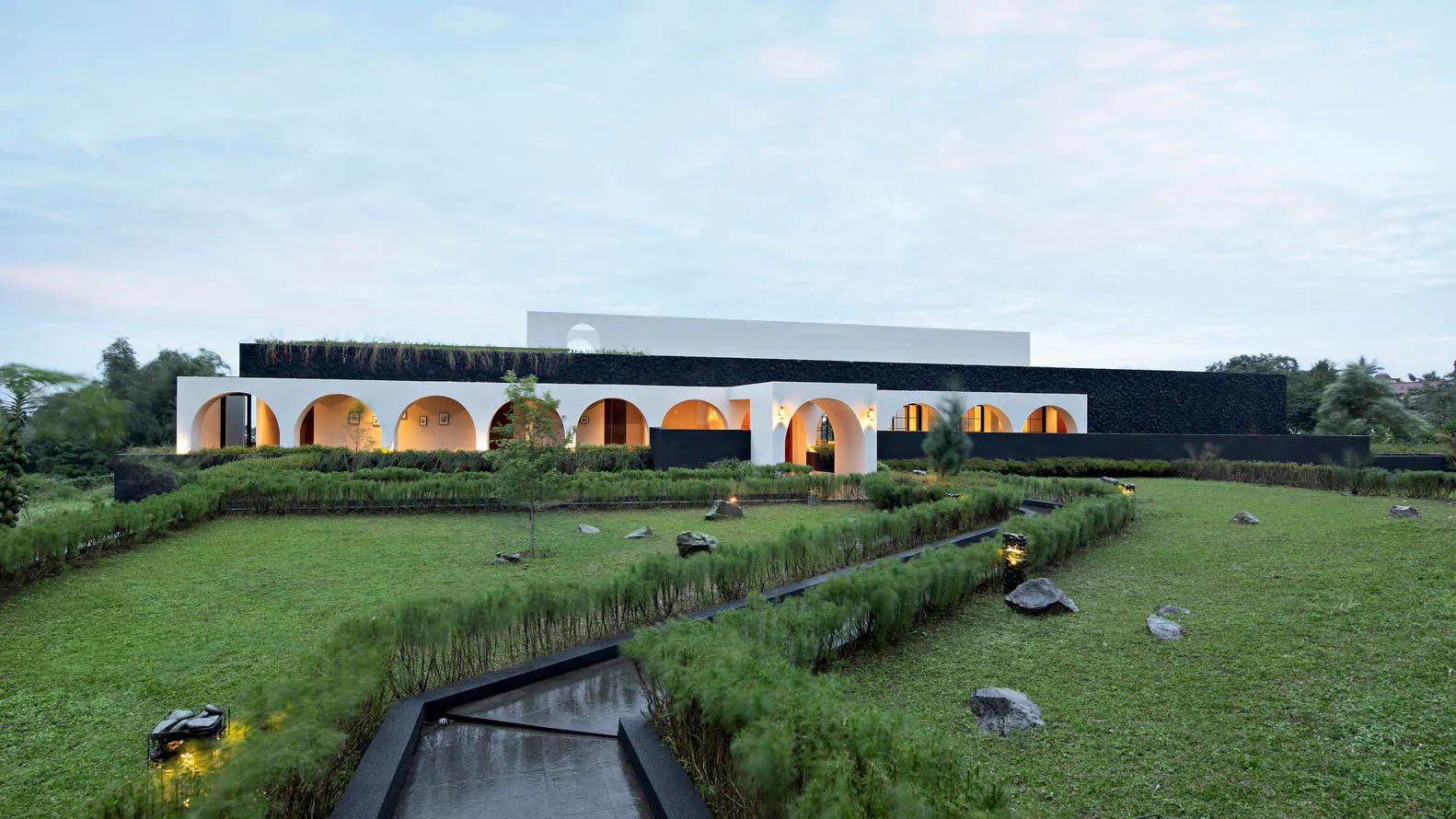 A contemporary residential building with modern concrete and glass design elements.
