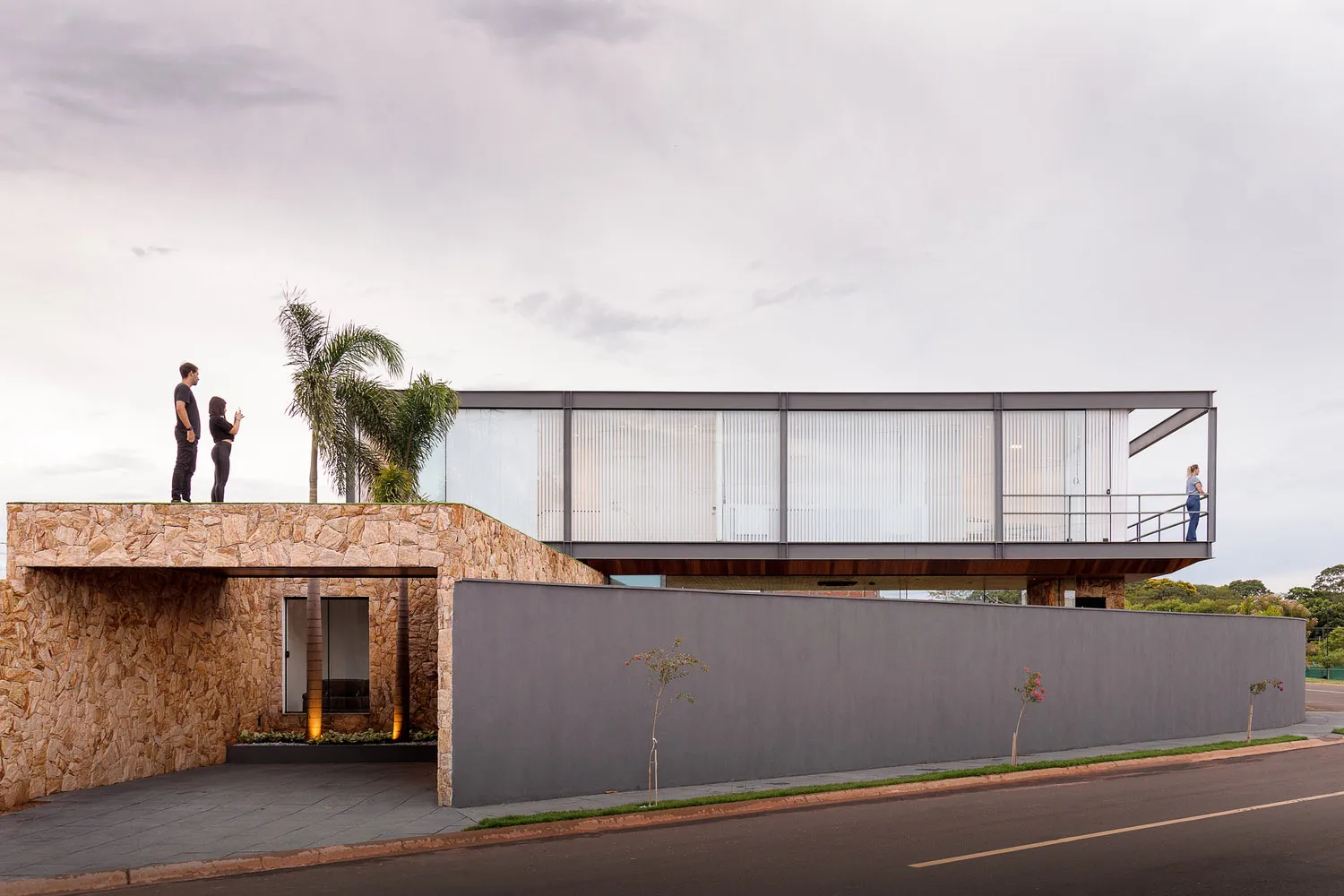 A modern building entrance with concrete walls and glass panels.