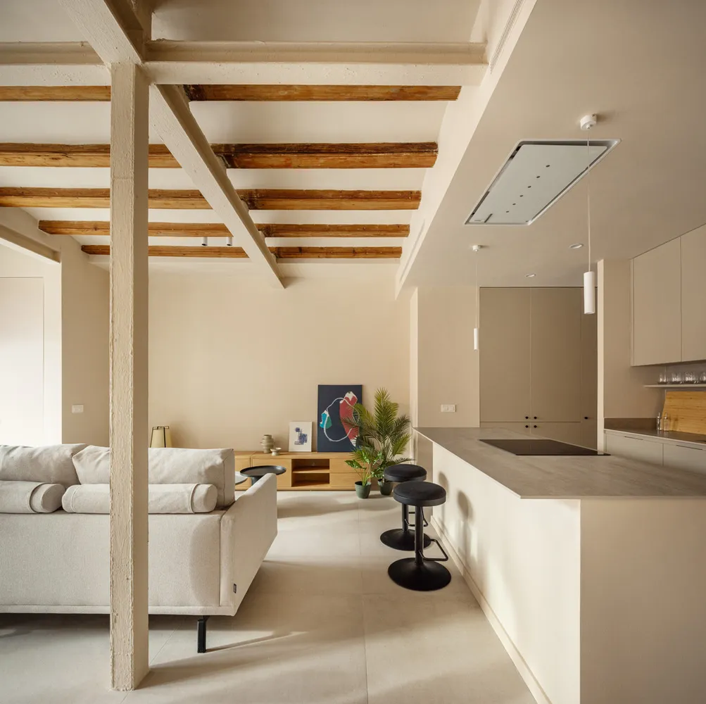 A modern residential kitchen featuring white concrete cabinets and minimalist design.