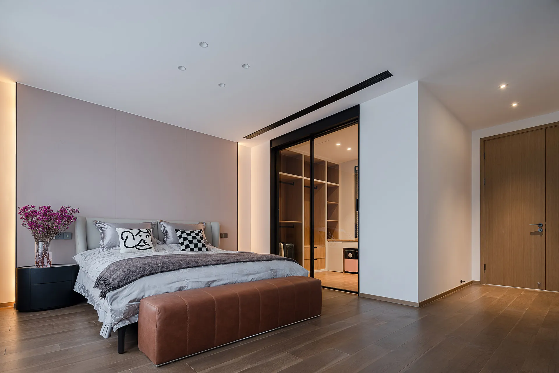 A modern bedroom featuring minimalist furniture with a neutral color palette and sleek lines.