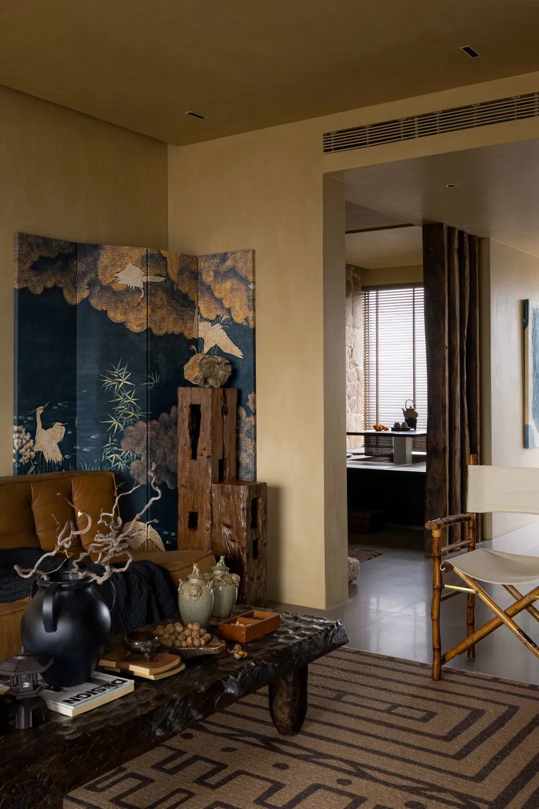 A minimalist living room with wooden furniture and decor.