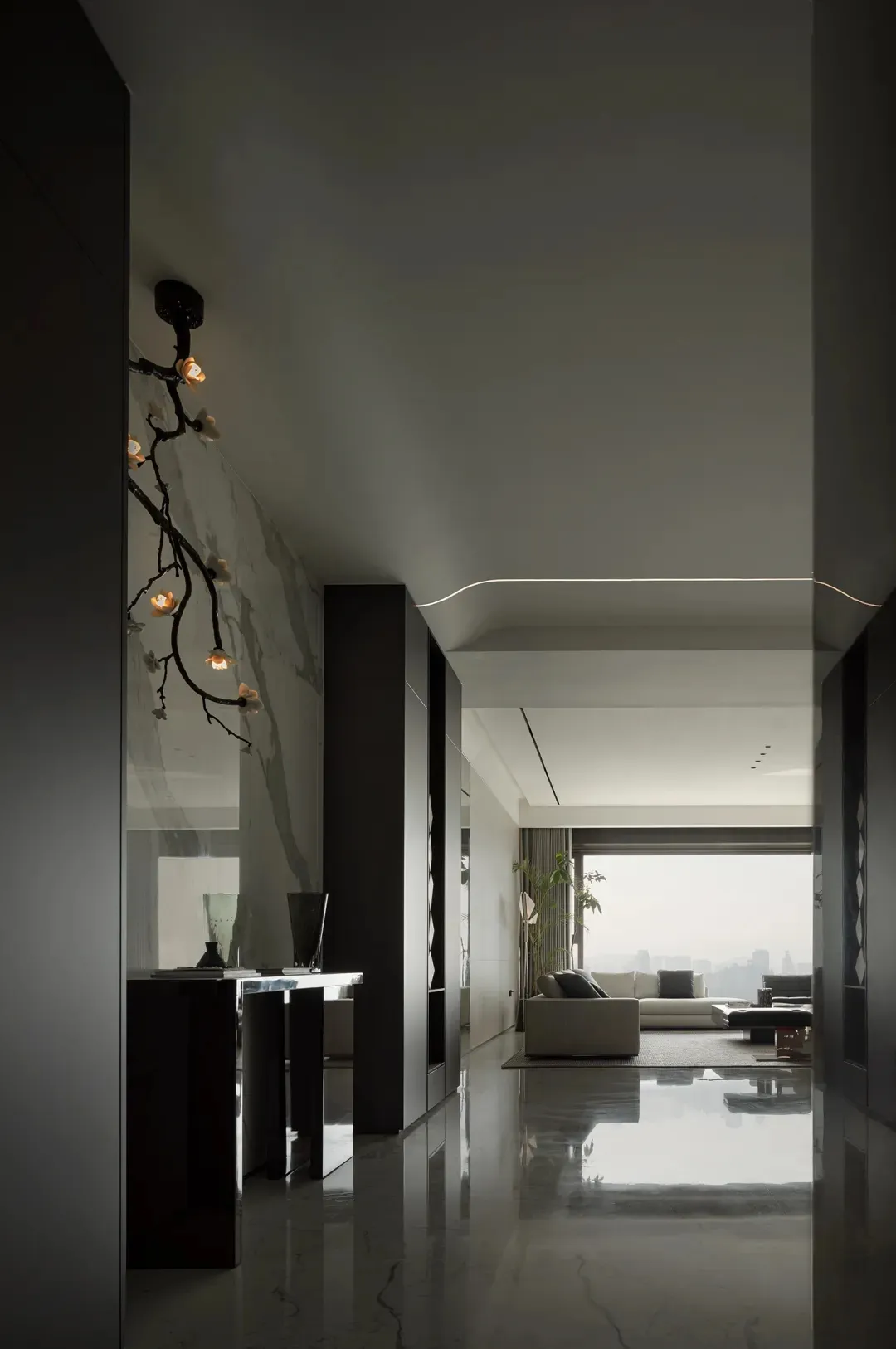 Modern minimalist living room with glass walls and marble flooring.
