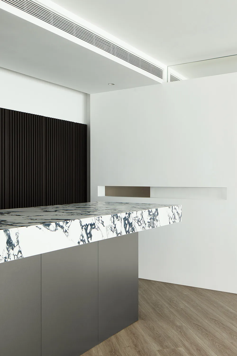 Modern office space with a marble countertop and dark wooden accents.