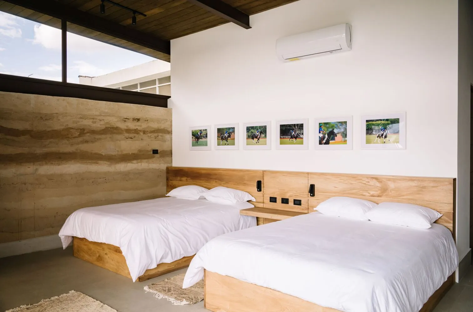 Minimalist bedroom featuring wooden furniture and white bedding
