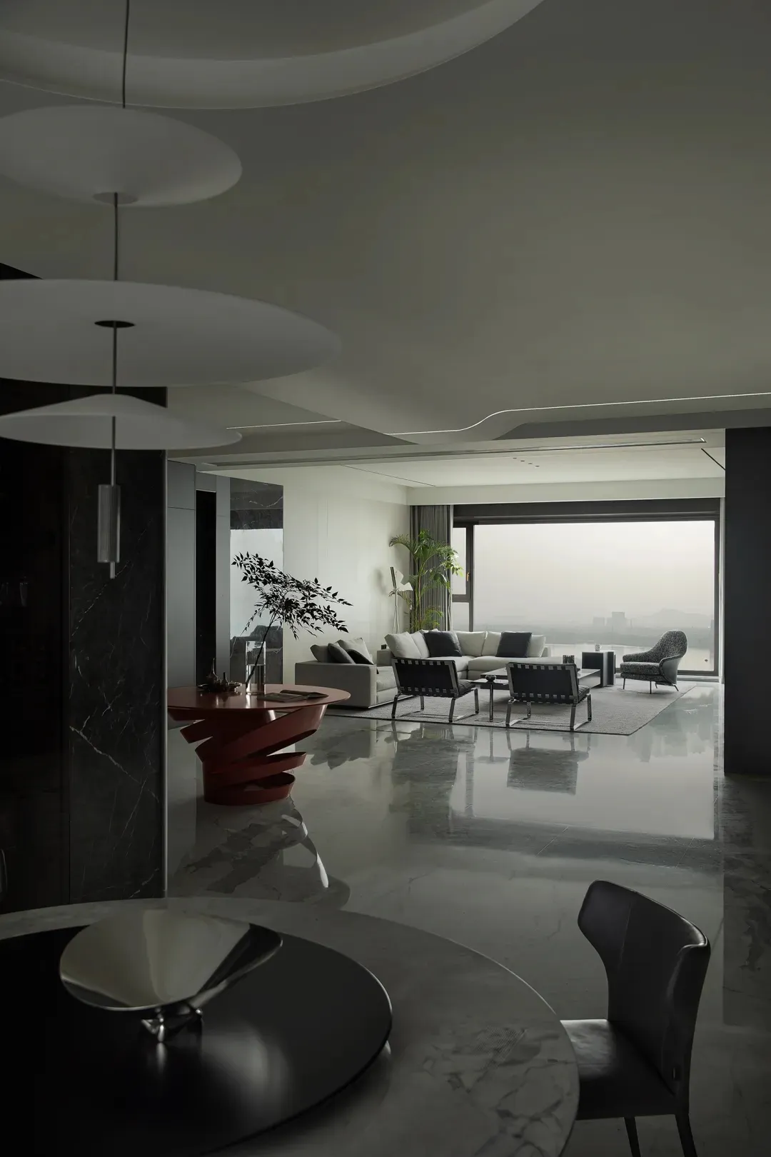 Modern minimalist living room featuring marble accents and a sleek, contemporary design.