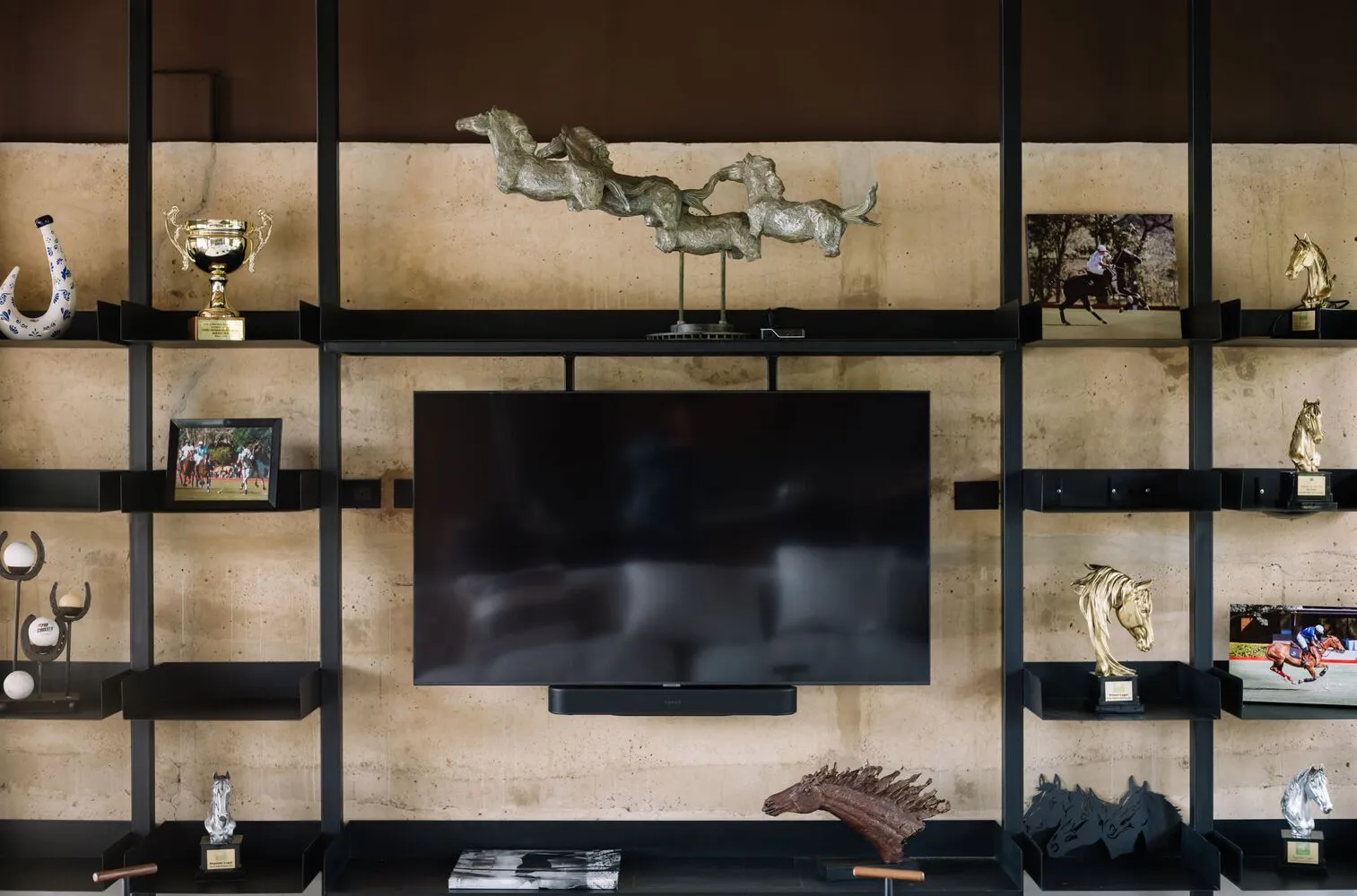 A modern urban space showcasing various trophies and sculptures on open shelves.