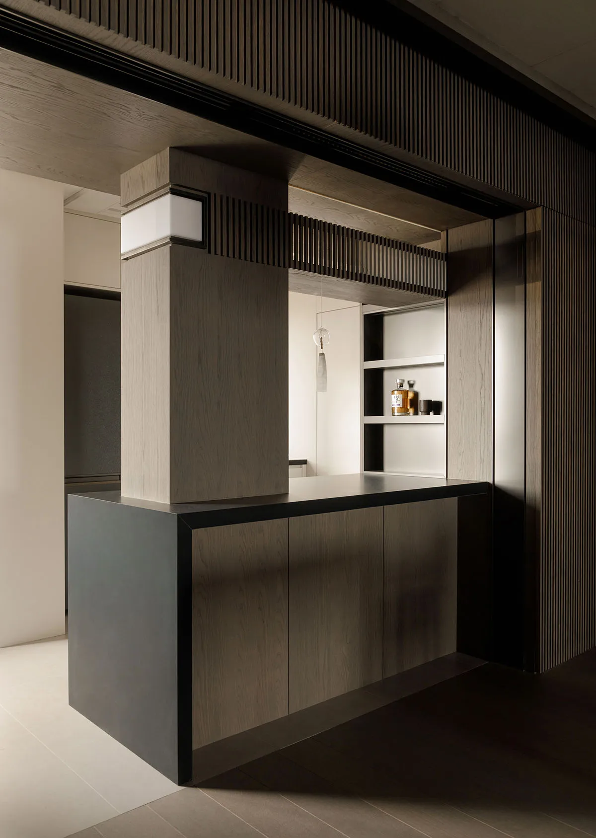 A dark wooden bar counter with a minimalist design, featuring a modern aesthetic and sleek lines.