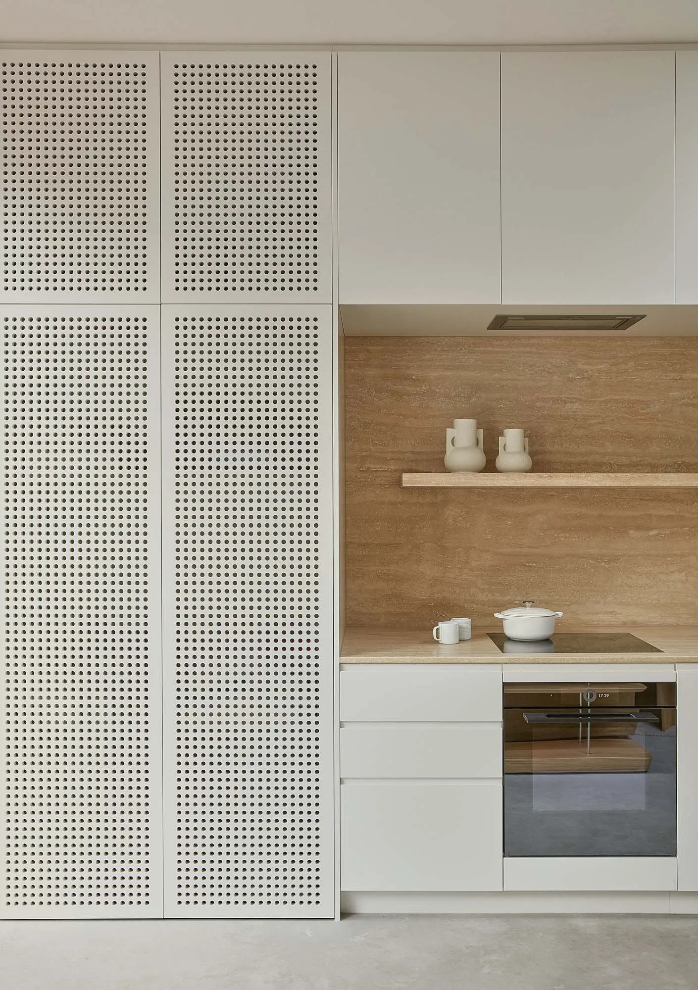 Modern minimalist kitchen with wooden finishes, featuring sleek white cabinets, a neutral color palette, and a thoughtful lay