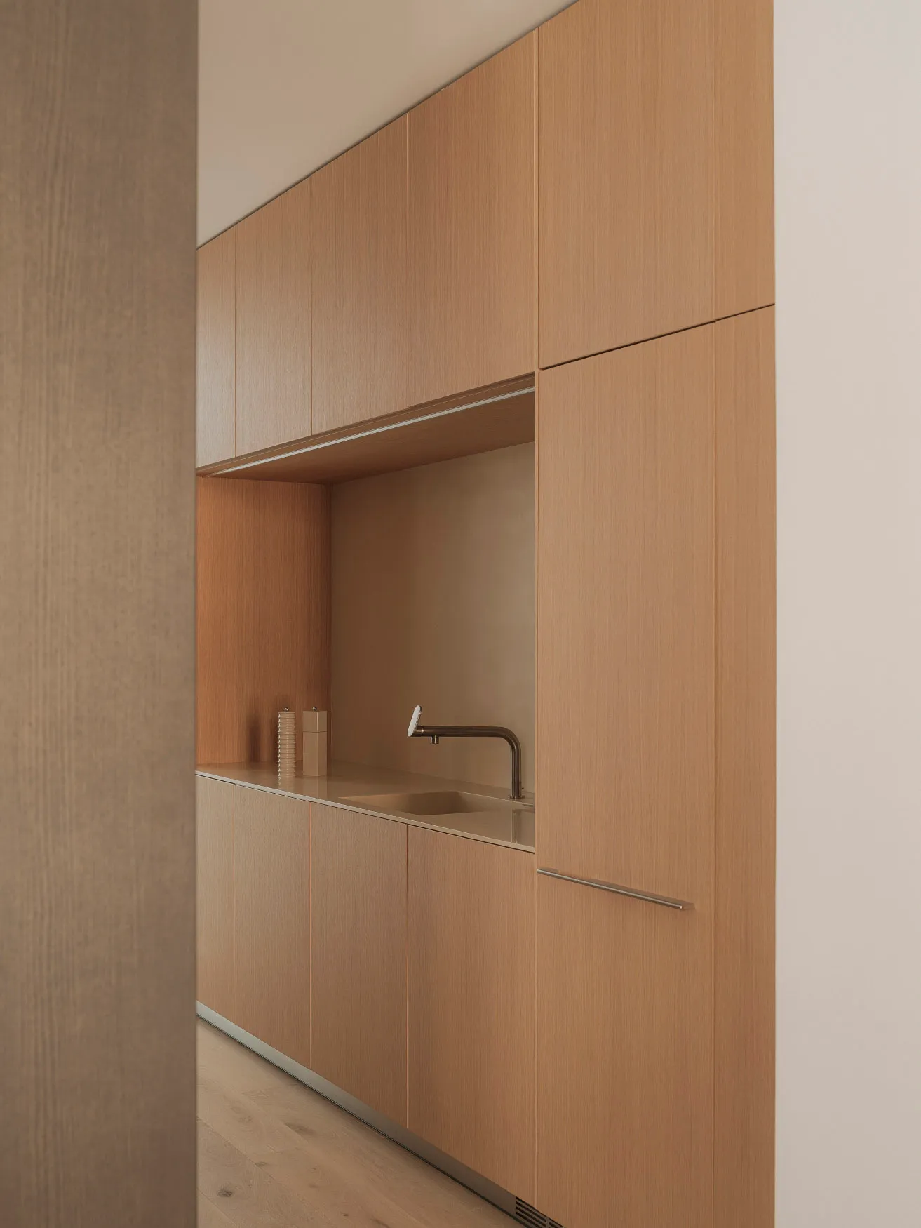 Modern residential kitchen featuring wooden cabinets and sleek design elements.