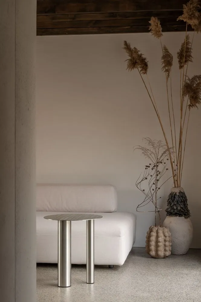Modern minimalist living room with contemporary furniture and abstract art on the walls.
