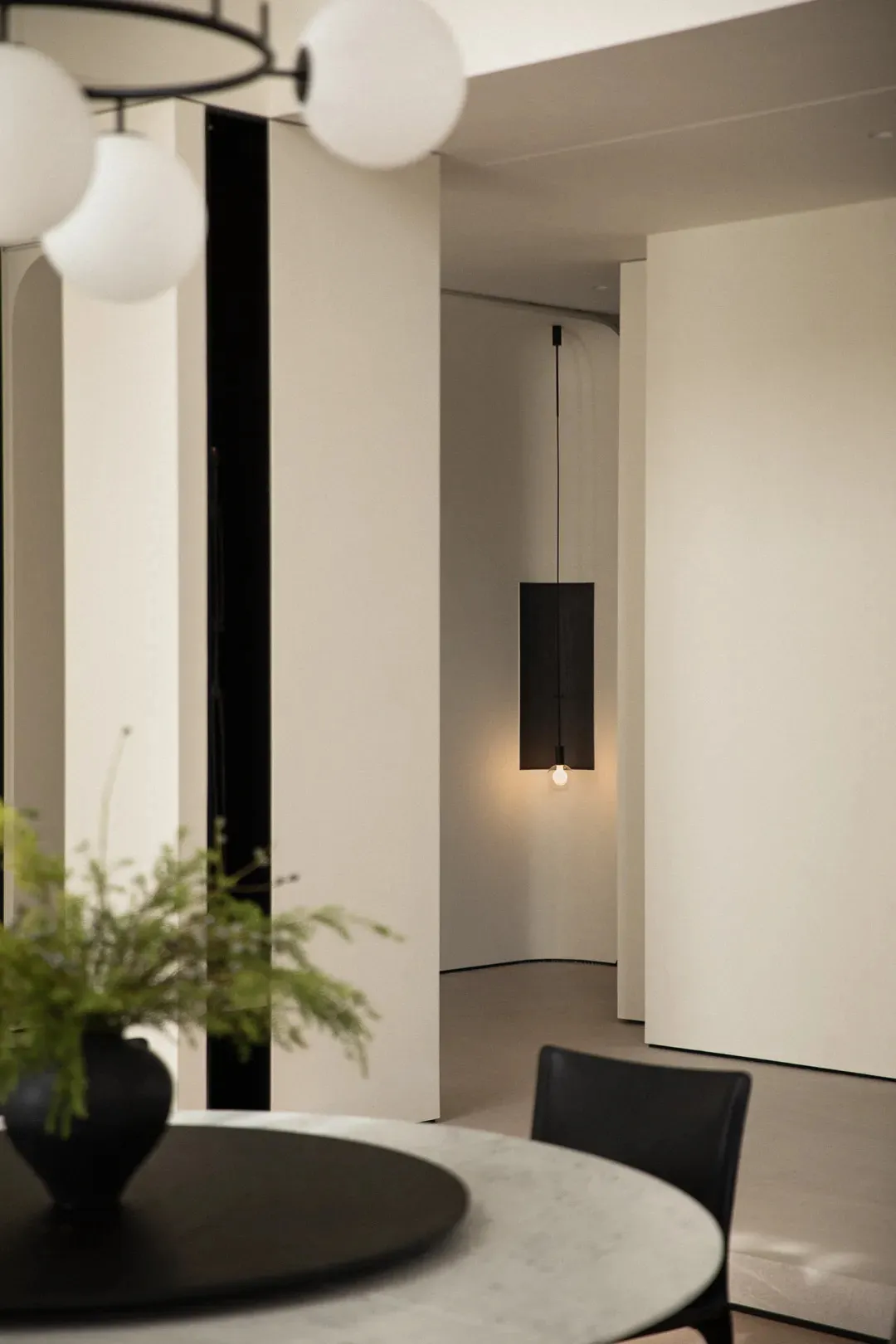 A minimalist space with modern lighting fixtures.