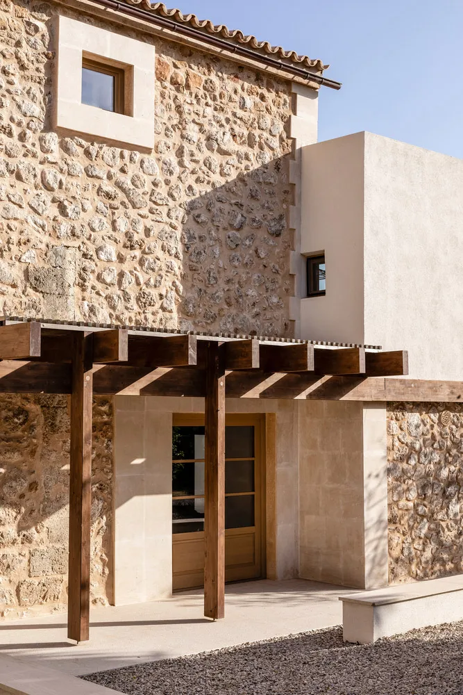 Modern house with stone exterior and wooden pergola