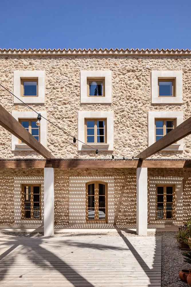 A stone building facade with wooden beams and blue sky