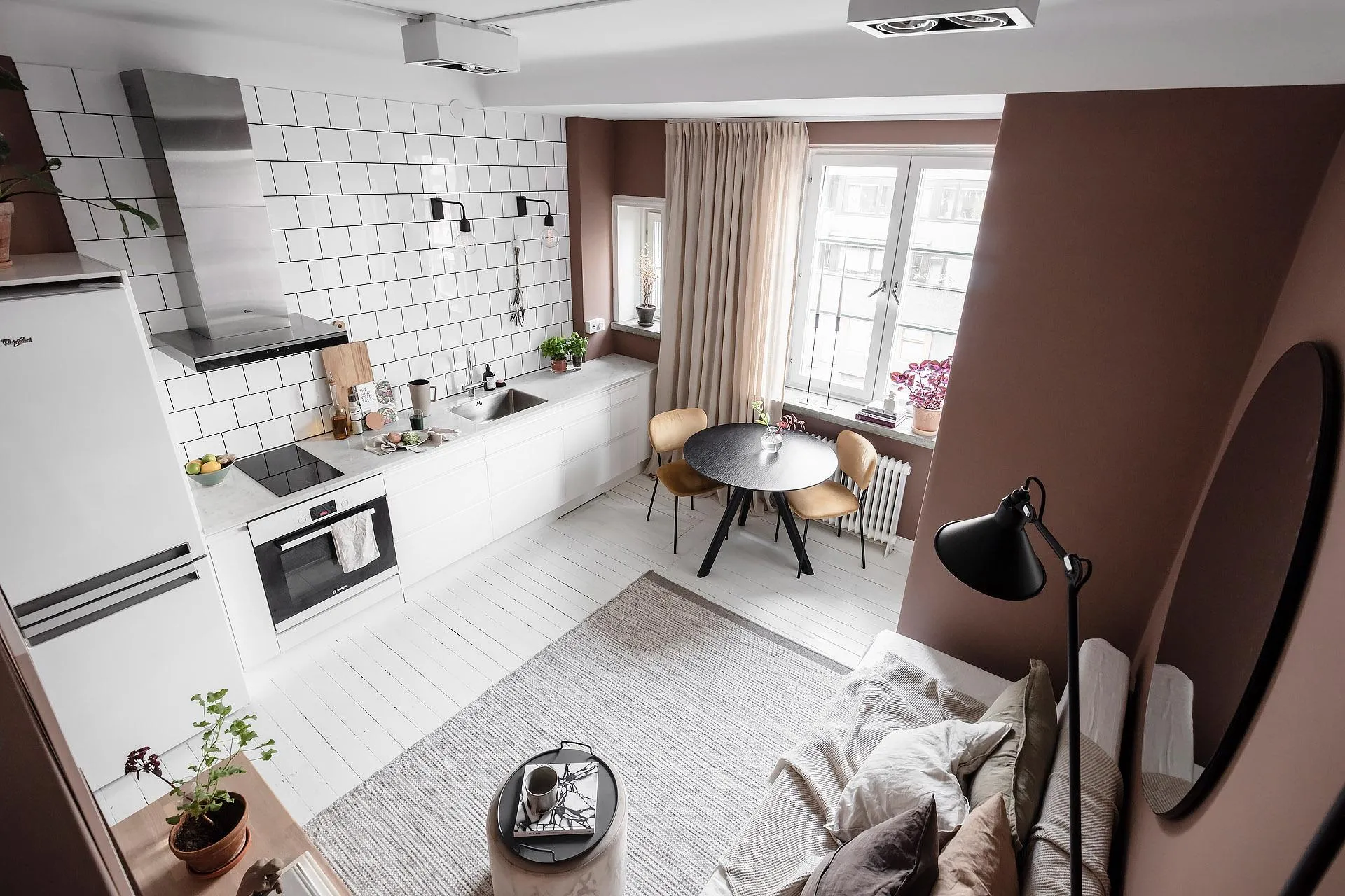 Modern minimalist living and dining room with neutral tones and functional design.