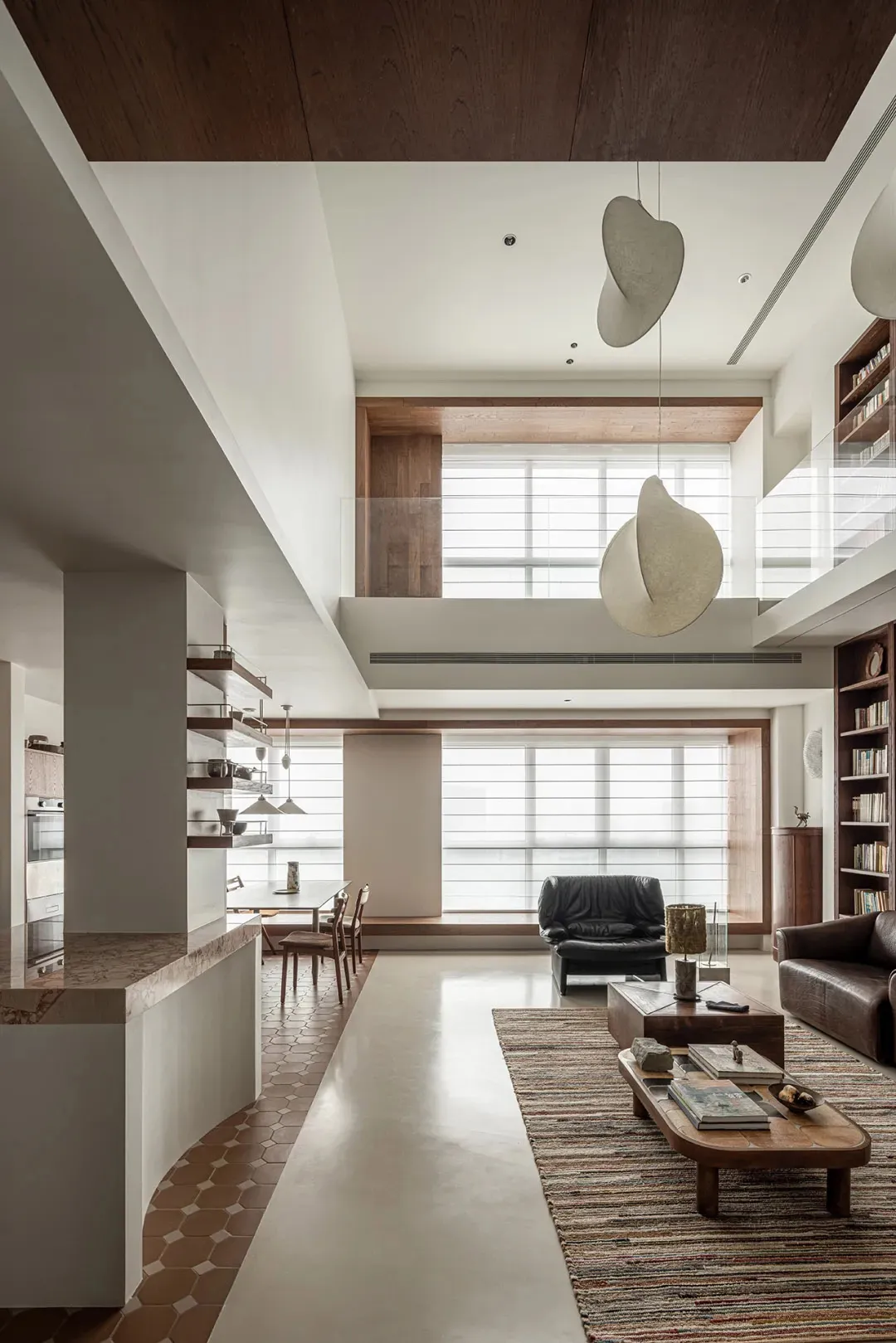 Modern living room featuring concrete walls and wooden furniture.