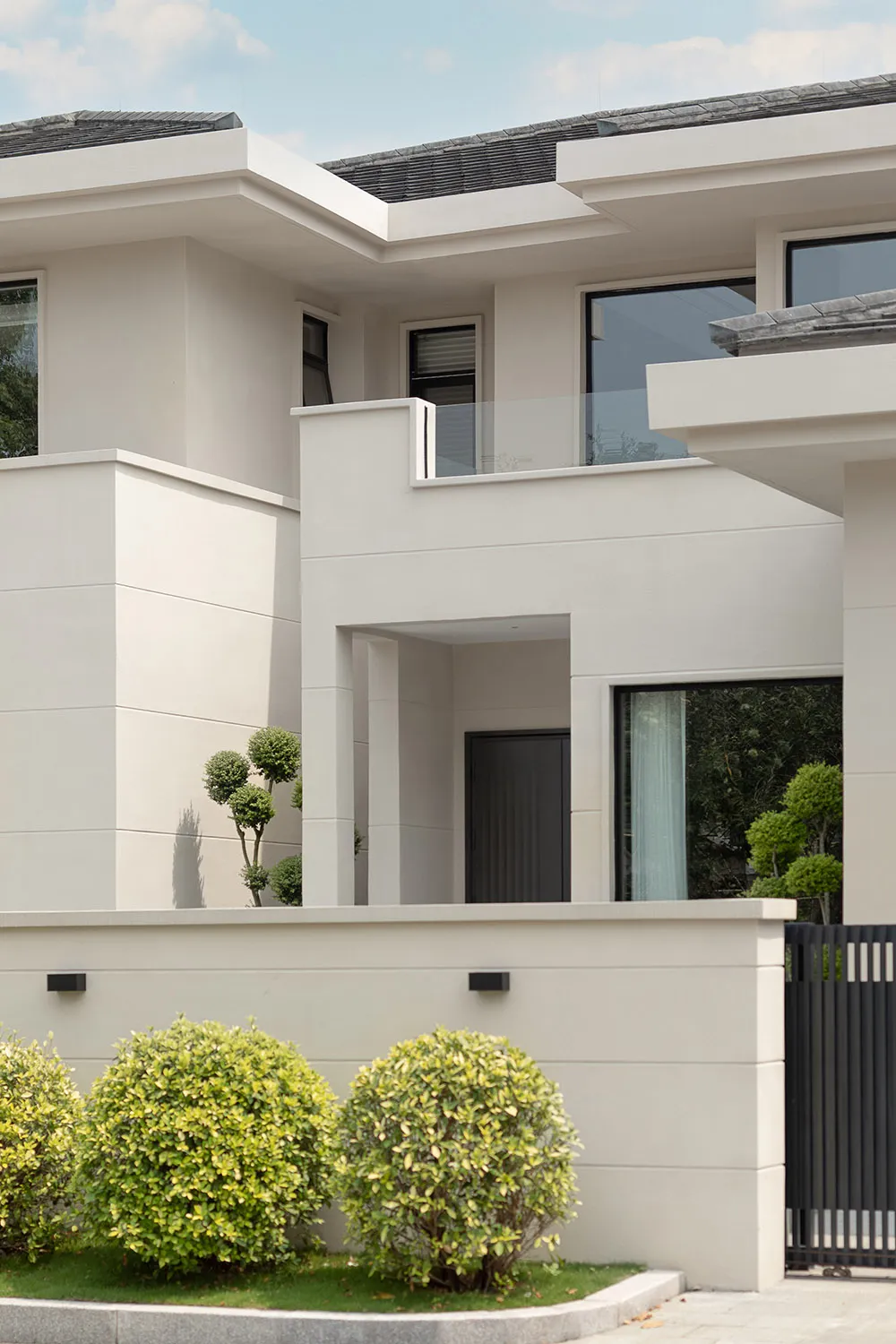 Modern residential exterior featuring concrete and glass materials