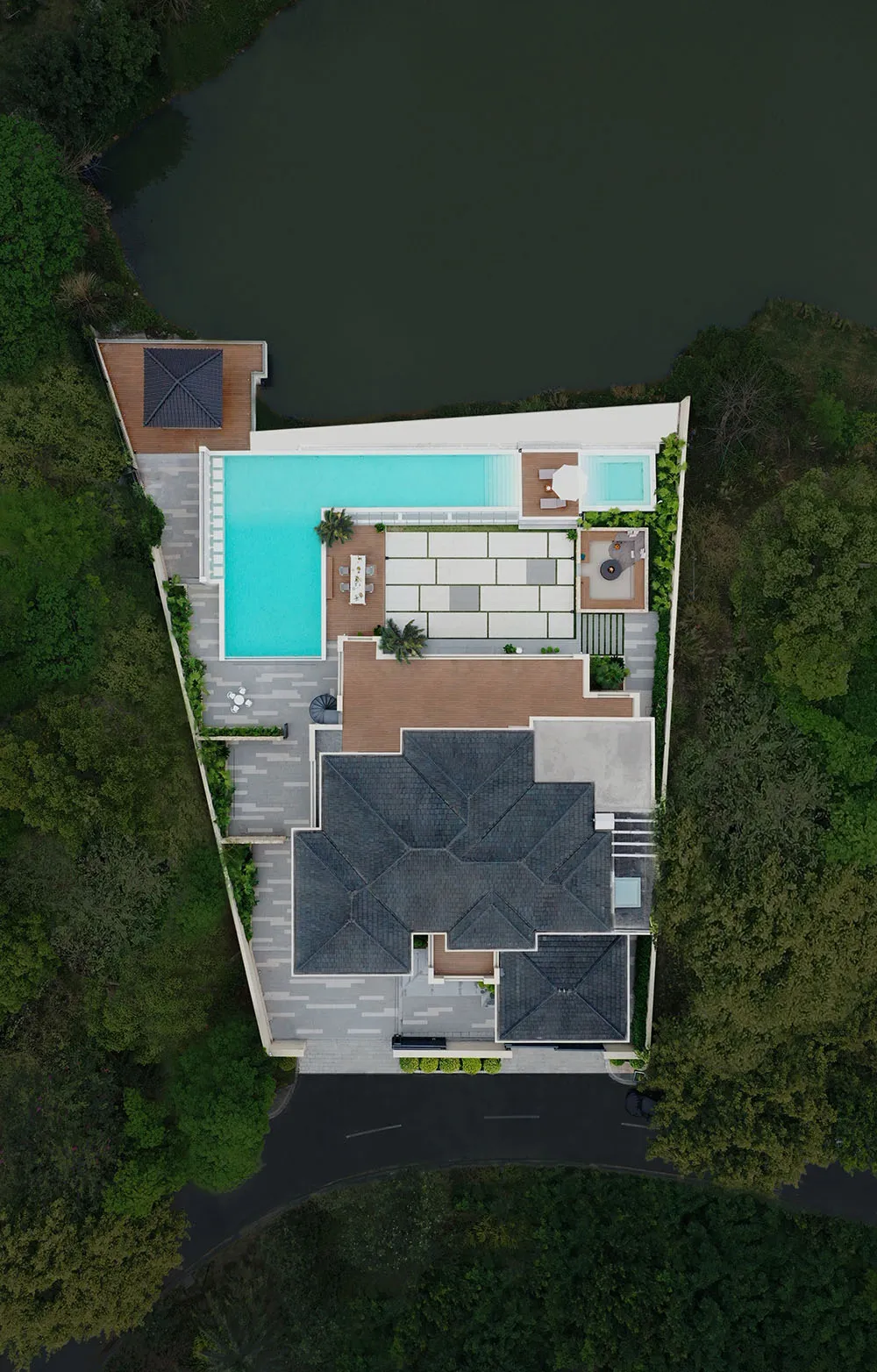 Aerial view of a modern residential floor plan featuring a pool, outdoor seating, and a rooftop terrace.