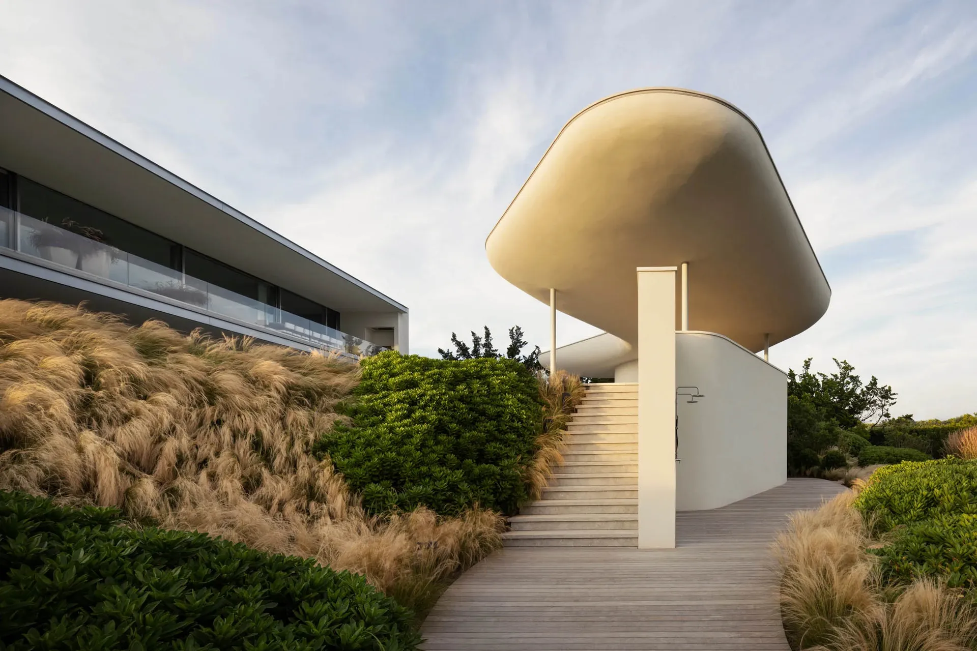 Modern house with minimalist design featuring concrete, glass, and wood materials.