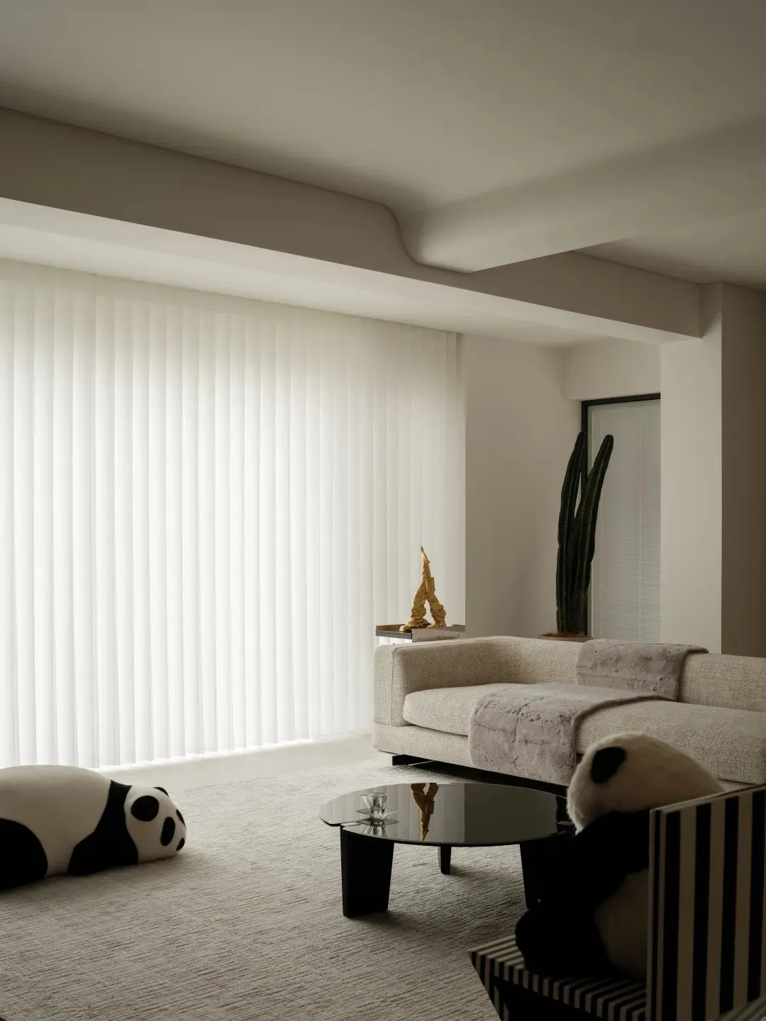 A modern living room with textured fabrics, a sofa, and a coffee table.