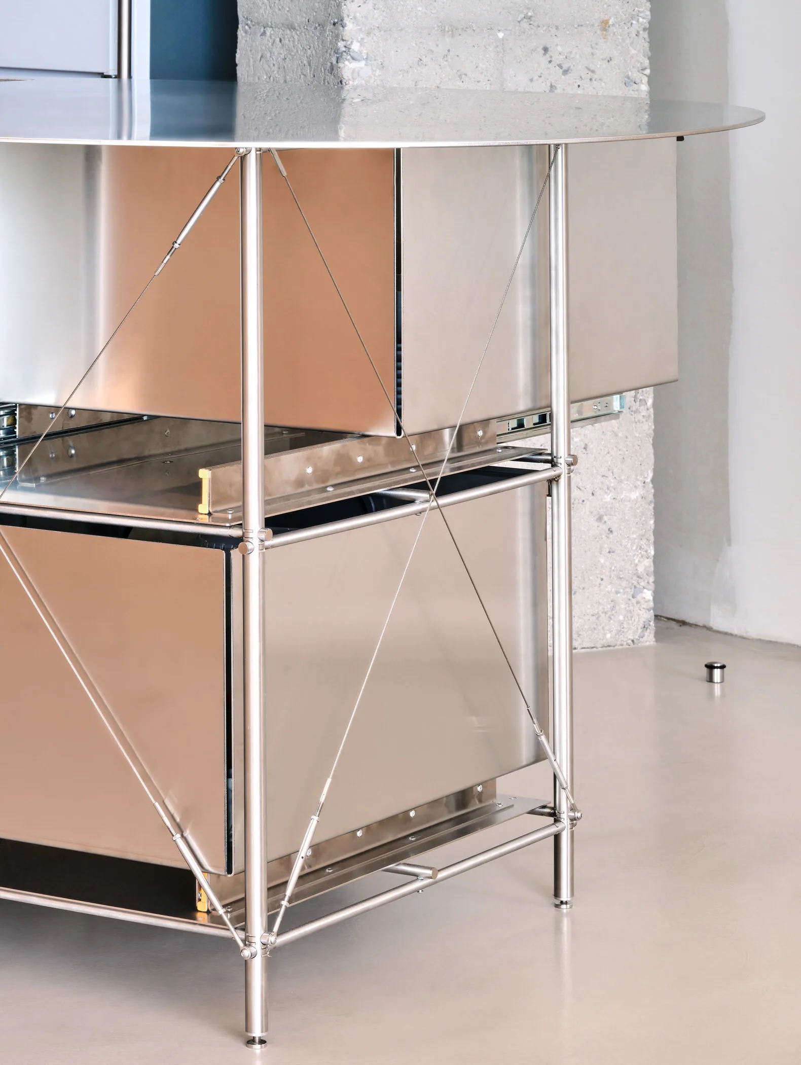 A modern kitchen cabinet made of metal with a sleek, minimalist design.