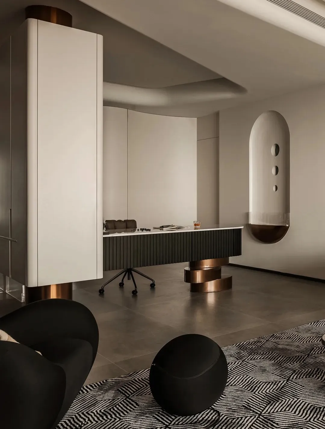 A minimalist office space featuring metallic furniture and accents.