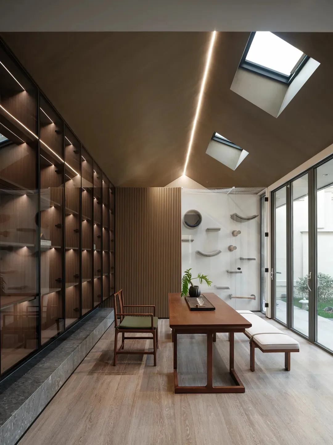 Modern interior design featuring wooden paneling, glass and cement elements, creating a casual retreat