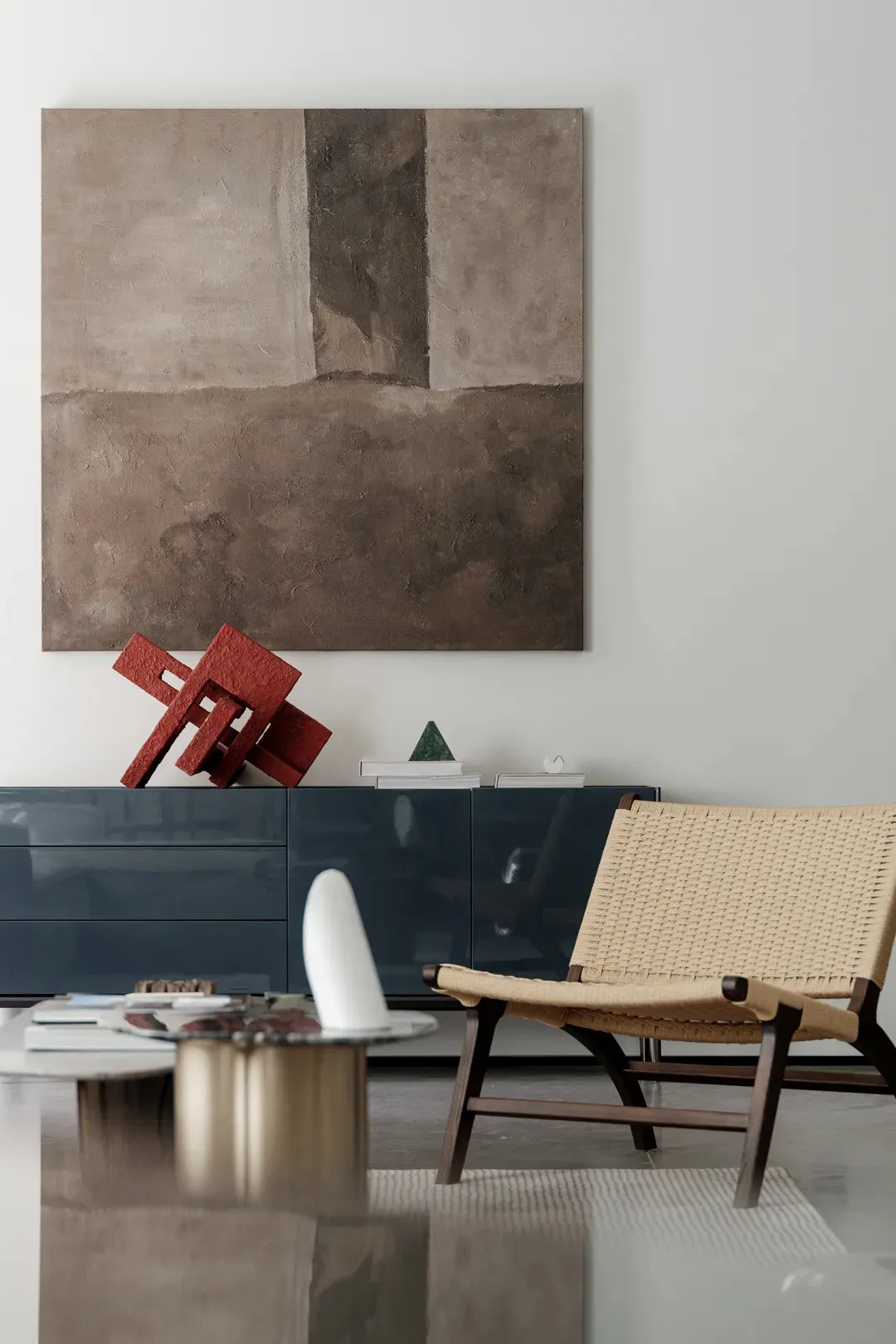 A modern living room featuring a metal sculpture as a focal point.