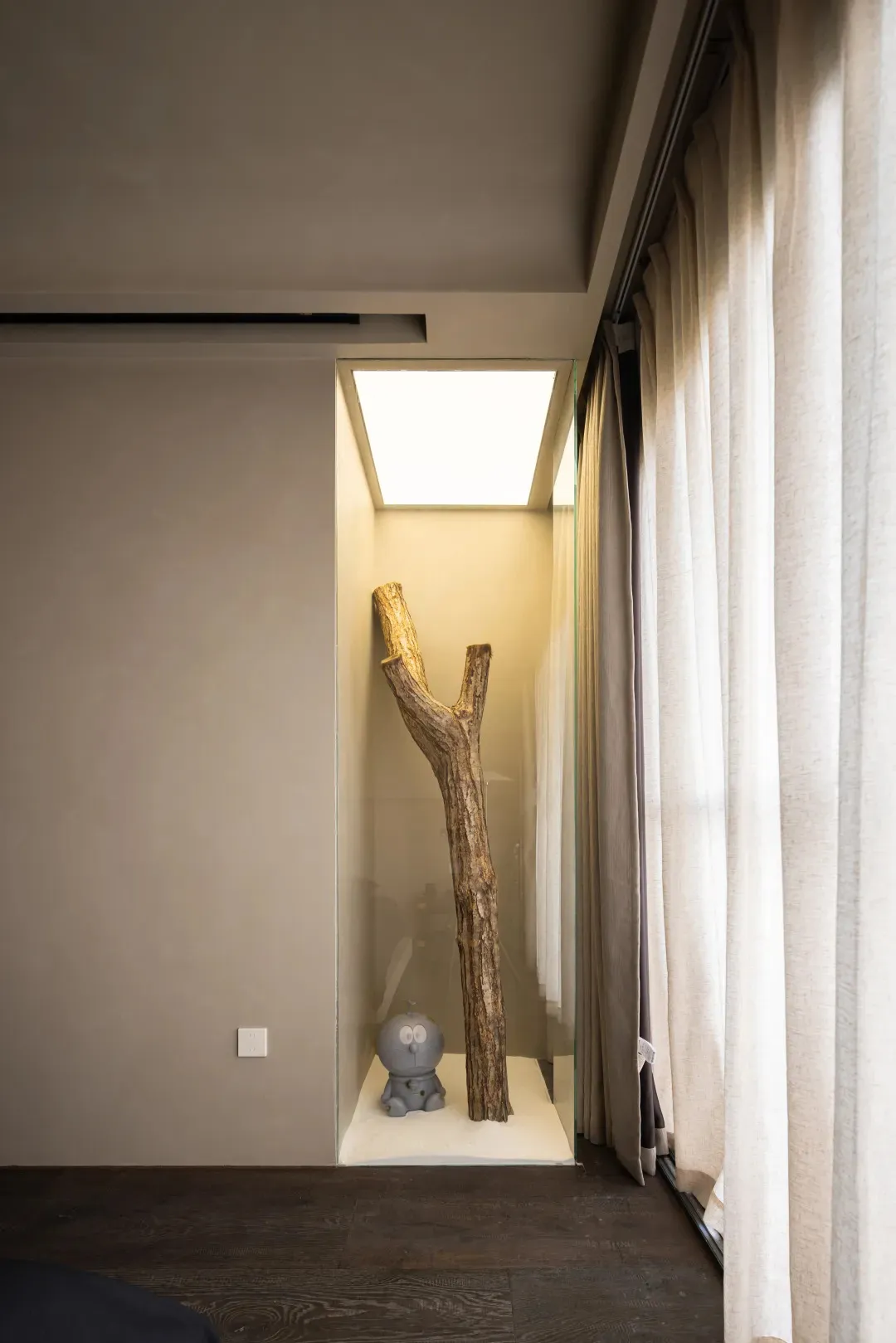 A minimalist bedroom featuring a wooden trunk as a unique decorative element.