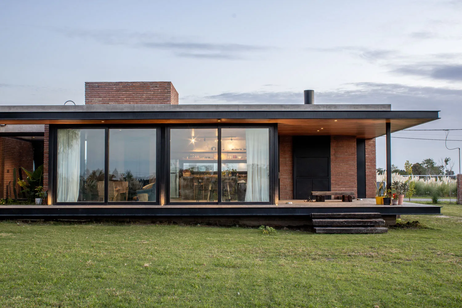 A minimalist house with brick and glass exterior.