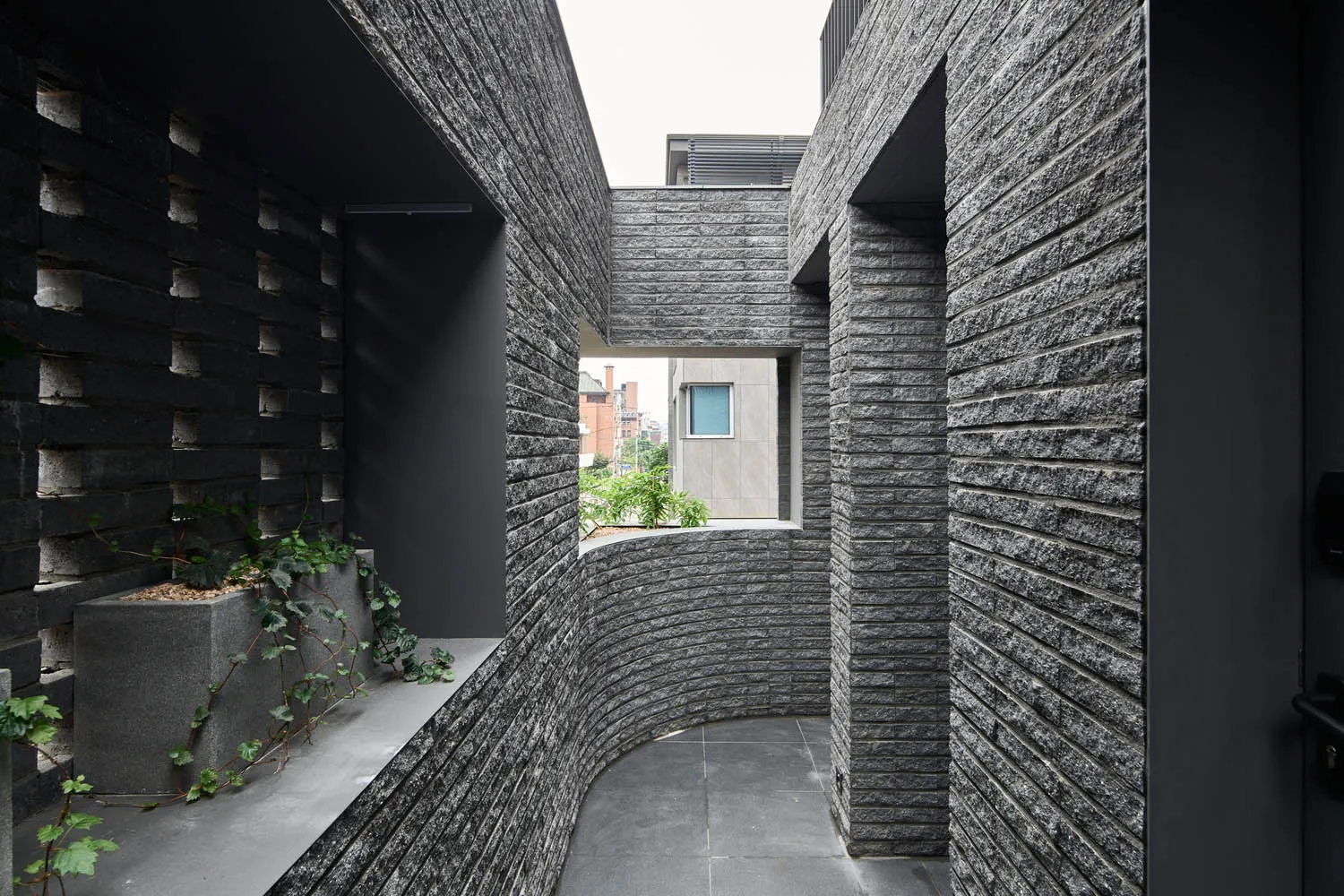 A photograph of a modern interior space with concrete walls, showing a minimalist design aesthetic.