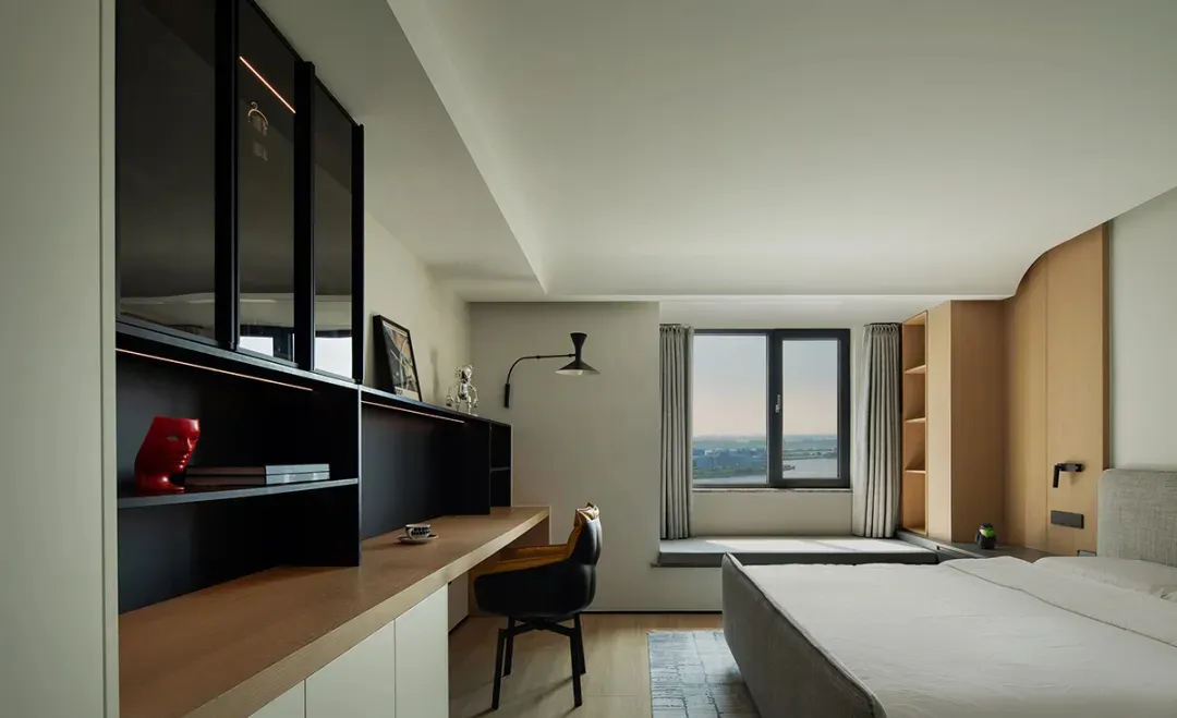 A minimalist bedroom featuring wood and glass elements.
