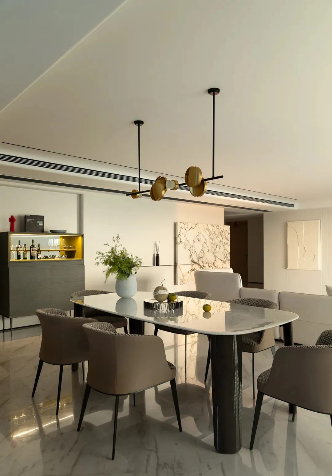 Modern dining room featuring a marble table and leather chairs, with a minimalist design.