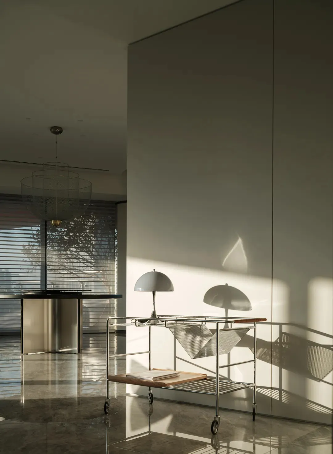 A modern interior featuring minimalist lighting fixtures with wire shades and glossy marble flooring, casting intricate shado