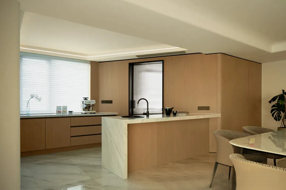 Contemporary residential kitchen featuring marble countertops and concrete flooring.