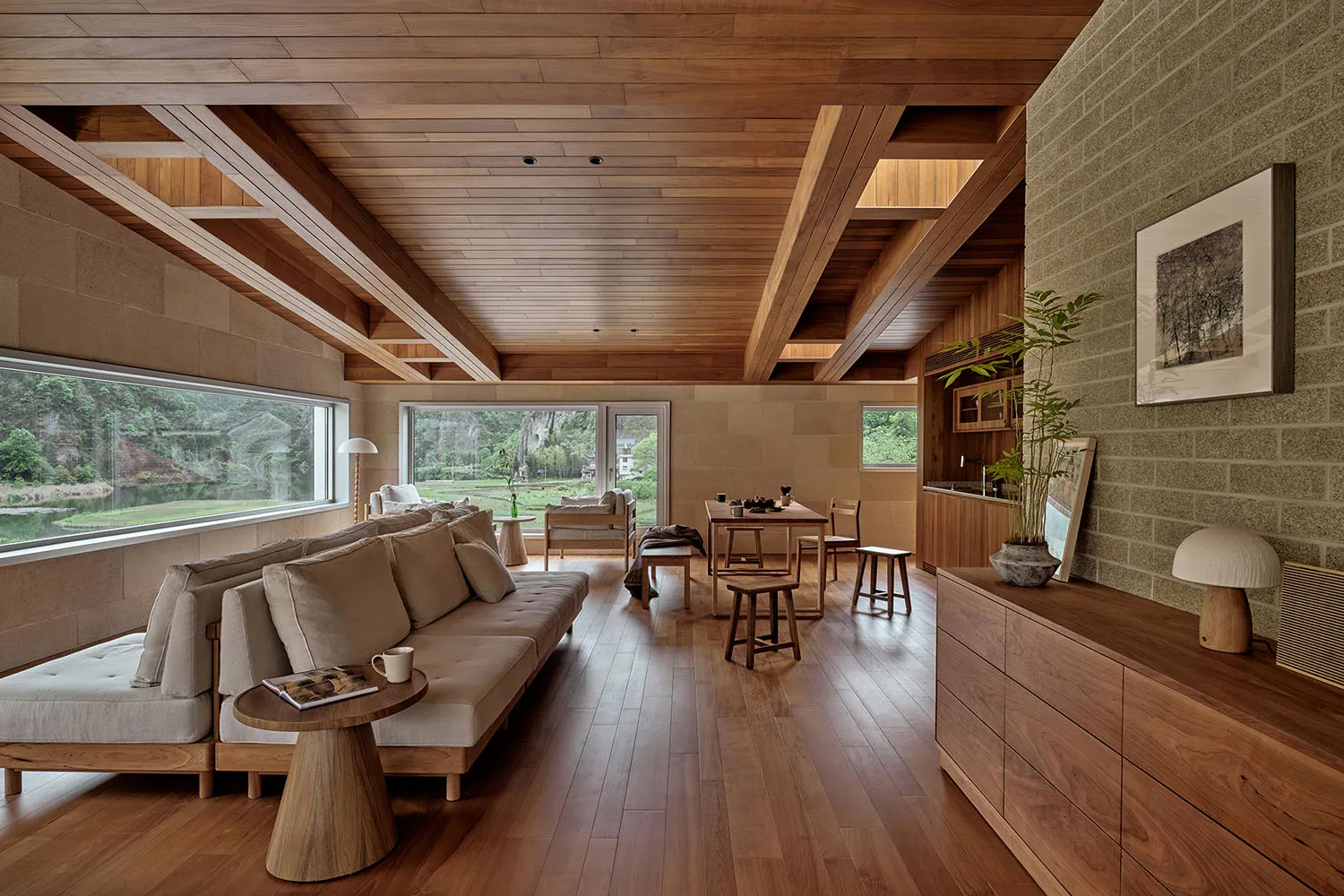 Modern living room featuring wooden flooring, a comfortable sofa, and a view of the outdoors.