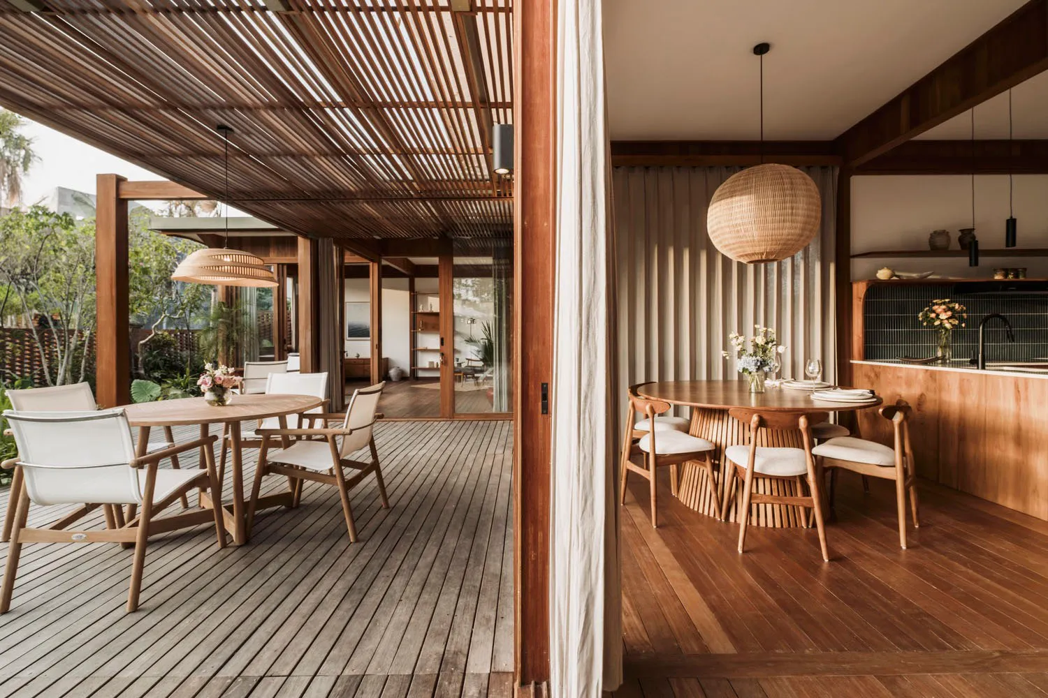 A modern residential dining room featuring wooden furniture and a natural light-filled space.