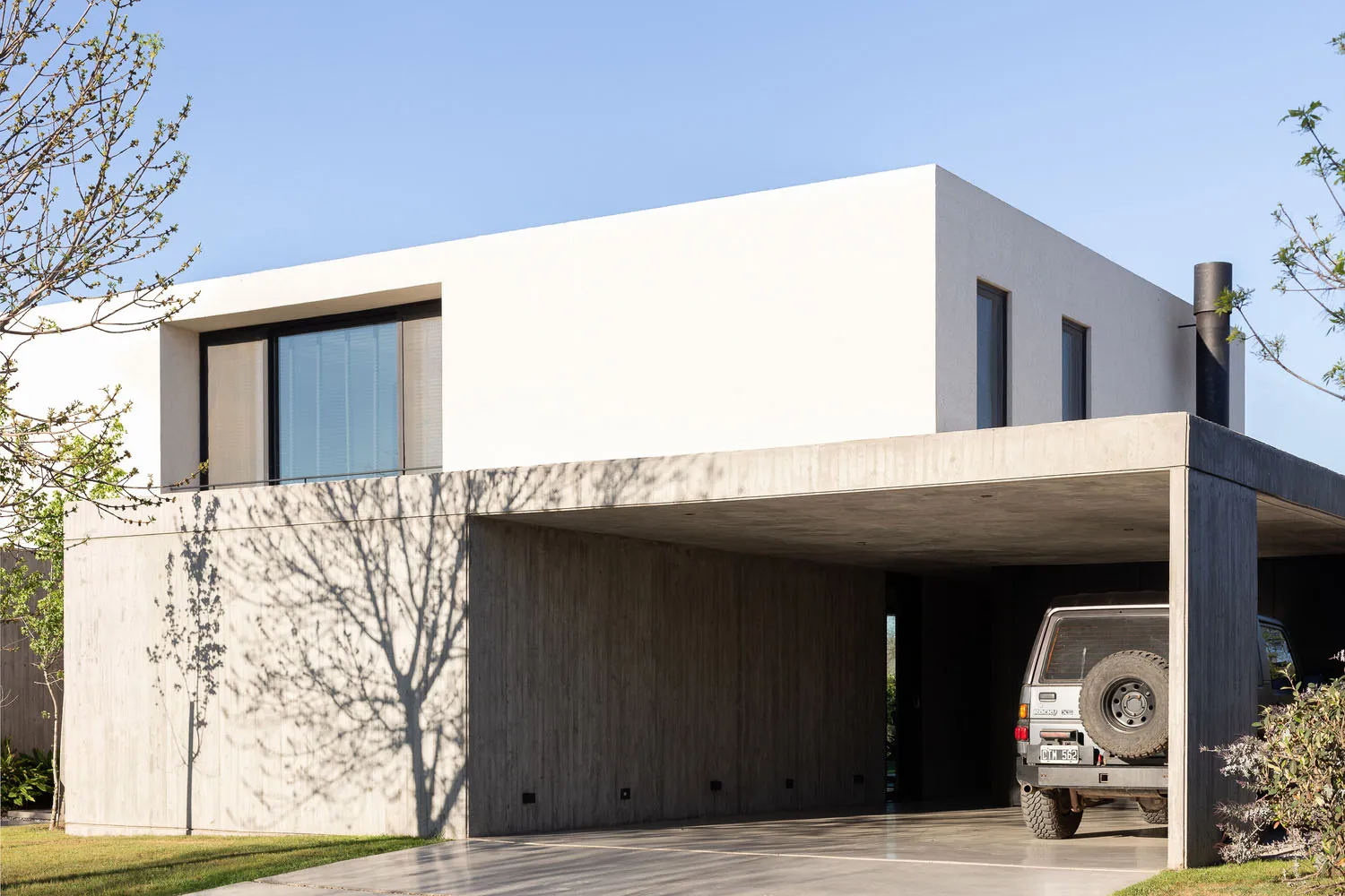 A minimalist, contemporary house with a concrete exterior.