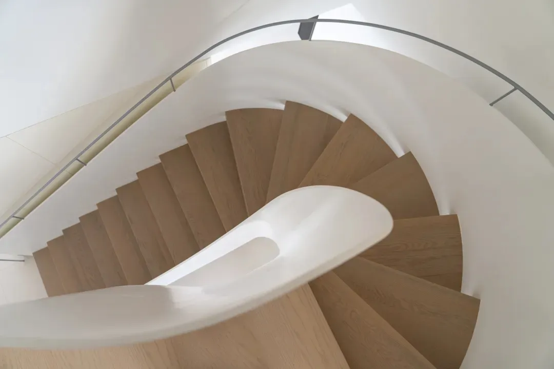 A minimalist staircase featuring wood and concrete materials.