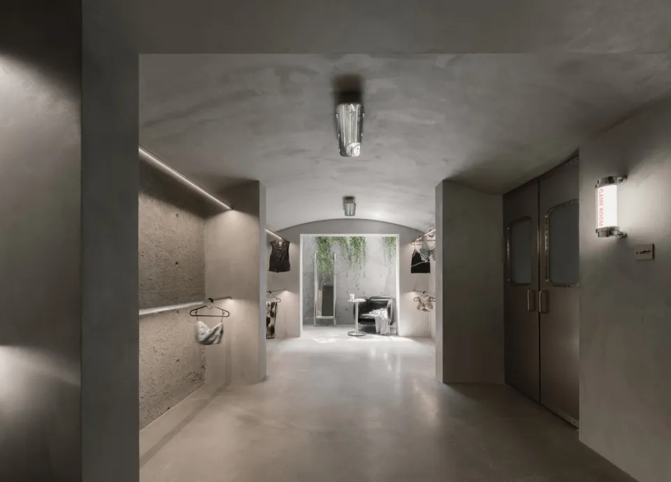 A modern industrial storefront with concrete walls and minimalist design features.