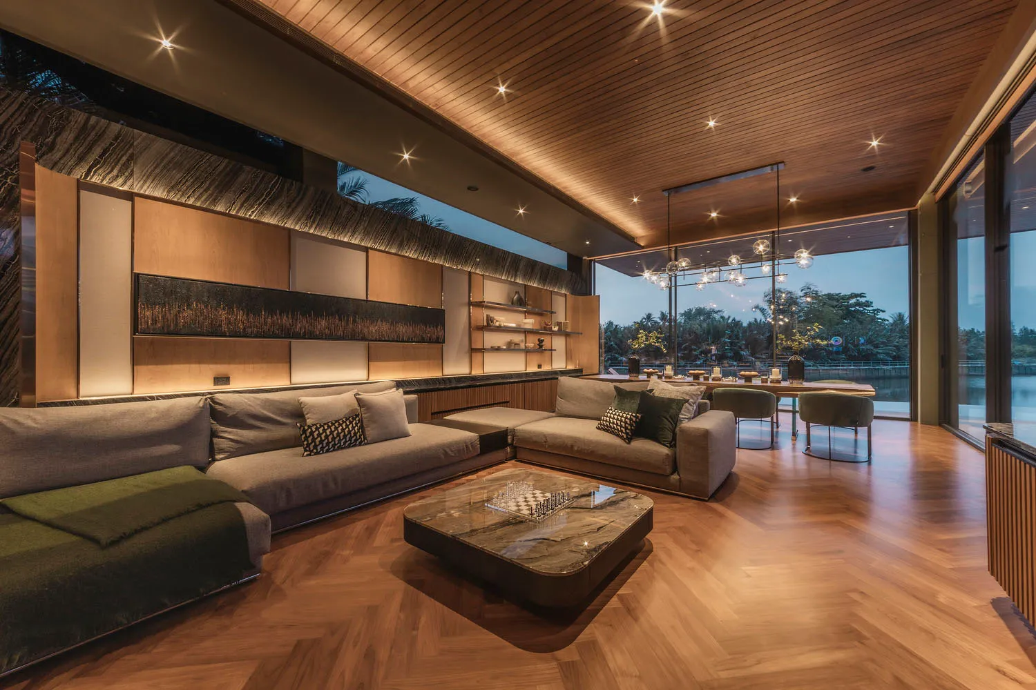 A modern living room featuring luxury furniture, marble coffee table, and wooden flooring.
