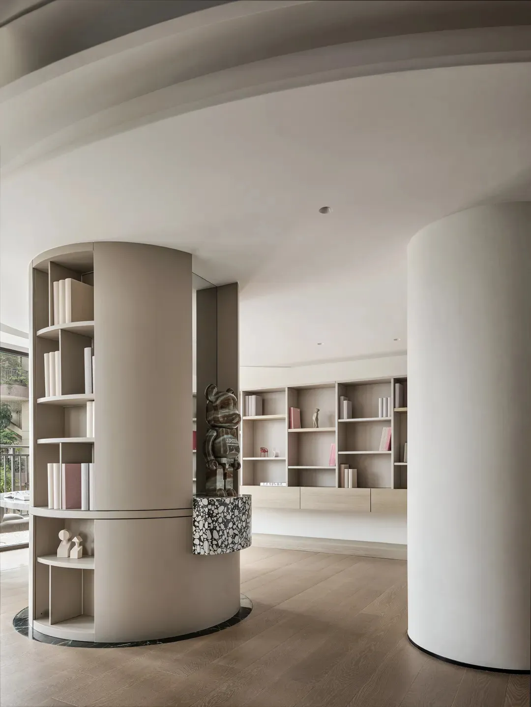 Contemporary office space featuring a minimalist design with a modern library area and composite panel elements.