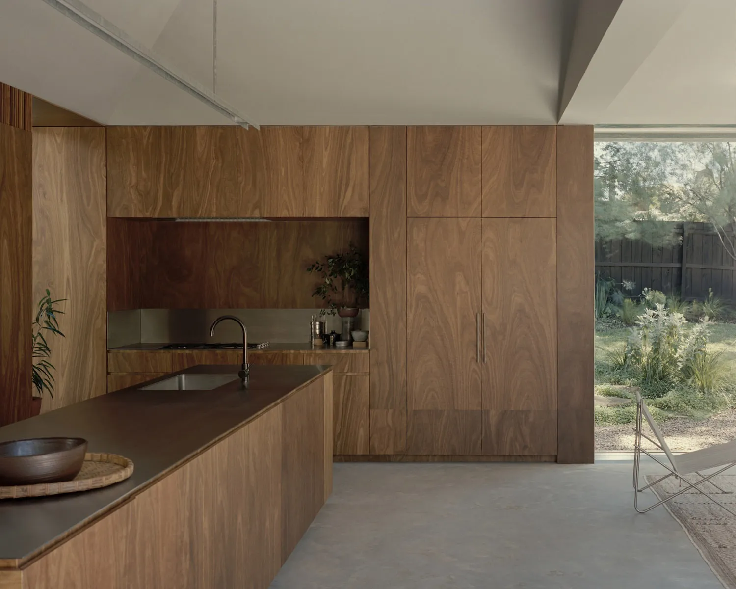 A modern residential kitchen with wooden cabinets and a large island.