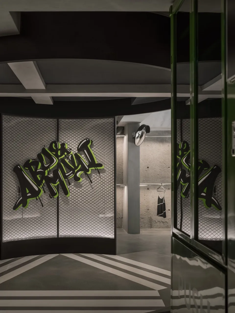 A modern retail shop featuring concrete walls with graffiti art, showcasing contemporary interior design elements.