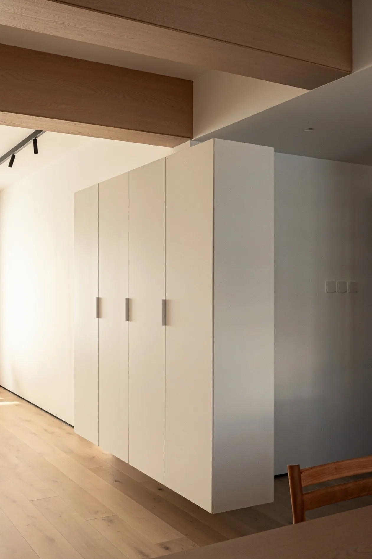 Modern minimalist cabinet with white painted surface and sleek, minimalistic design.