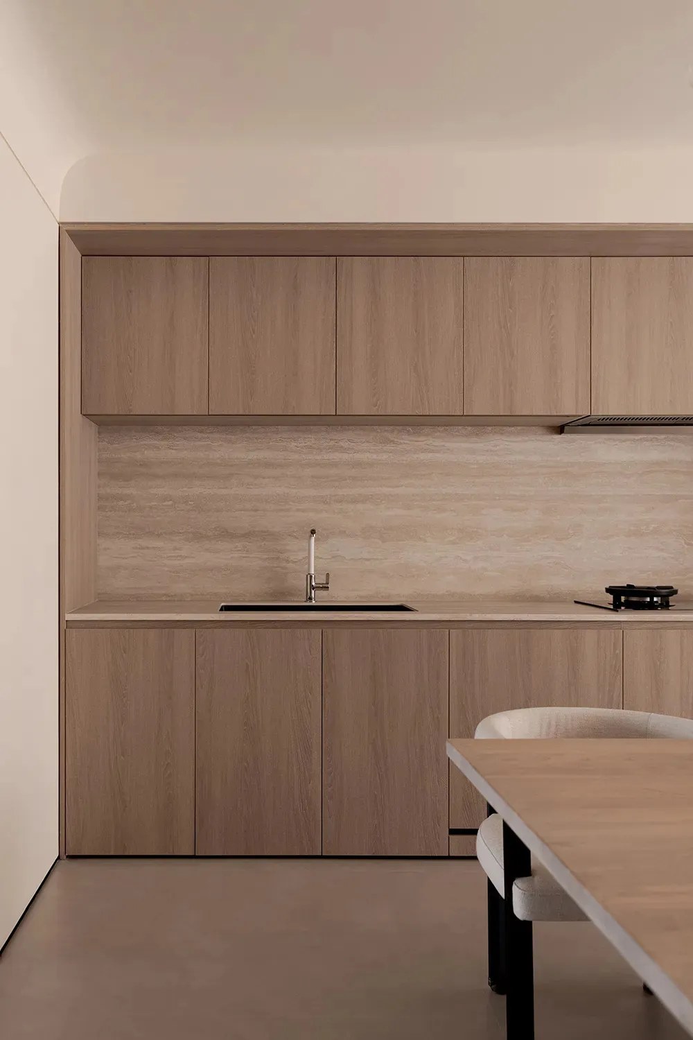 Modern, minimalist commercial kitchen with wooden cabinets and countertop.