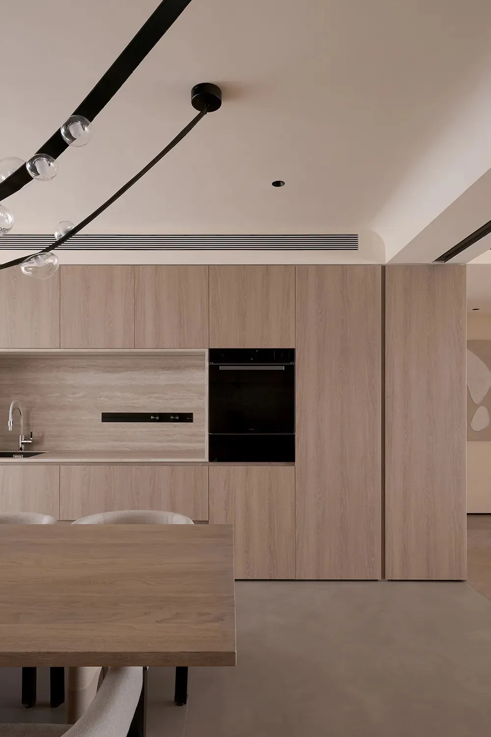 A minimalist kitchen with tiled flooring and wooden countertops.